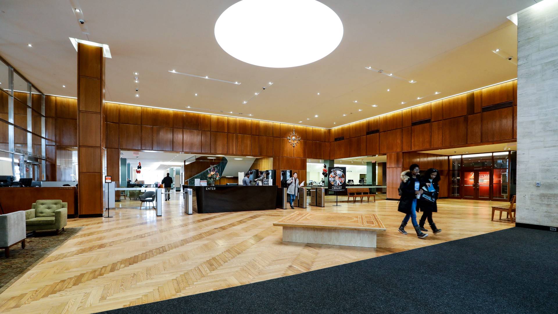Students walking through library lobby