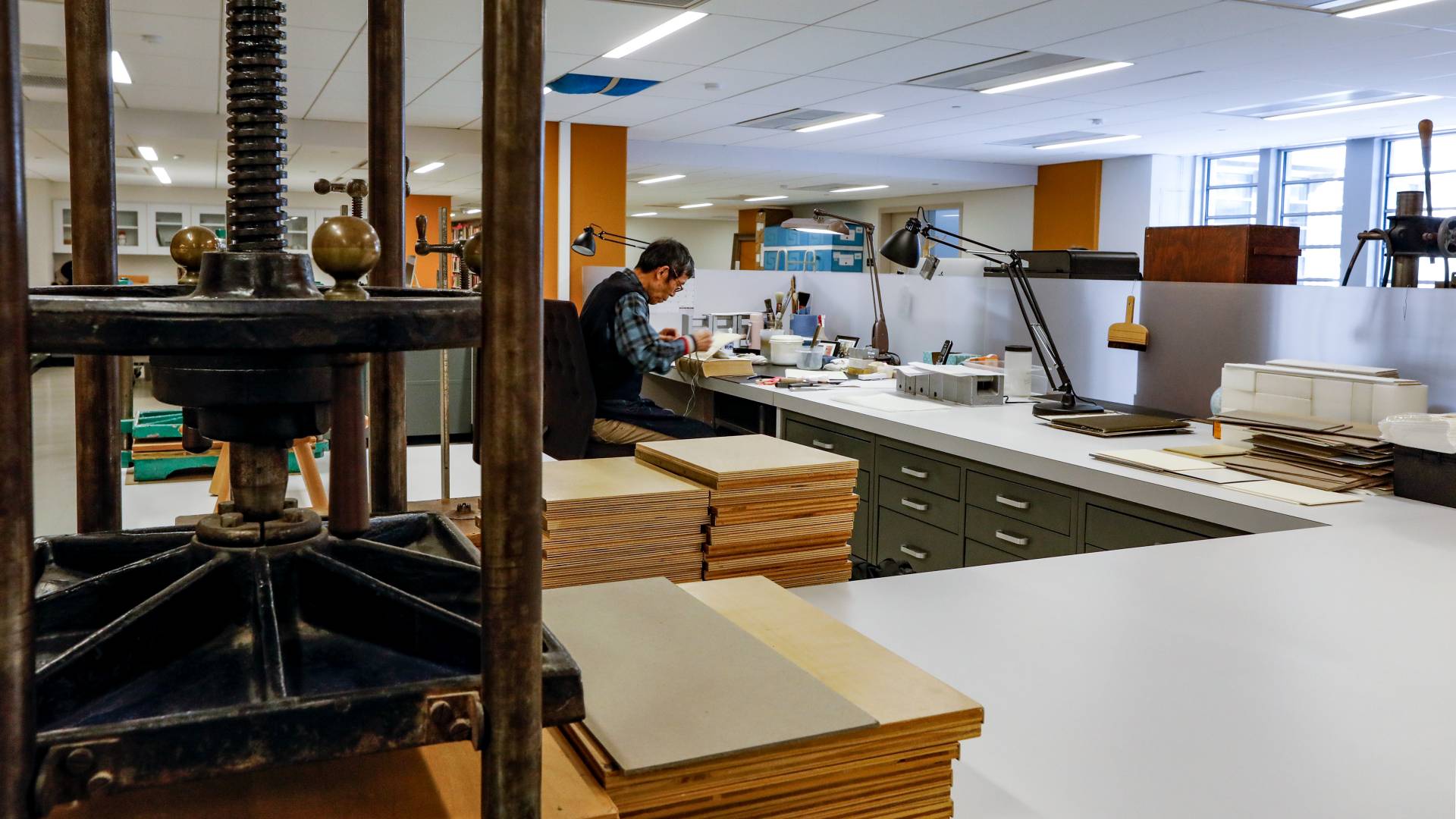 Librarian working at desk in library conservation lab