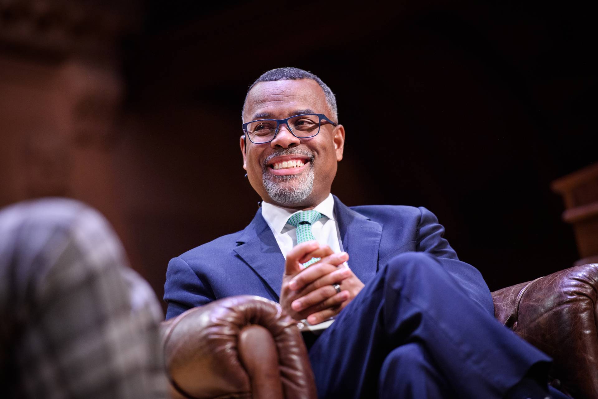 Eddie Glaude smiles on stage