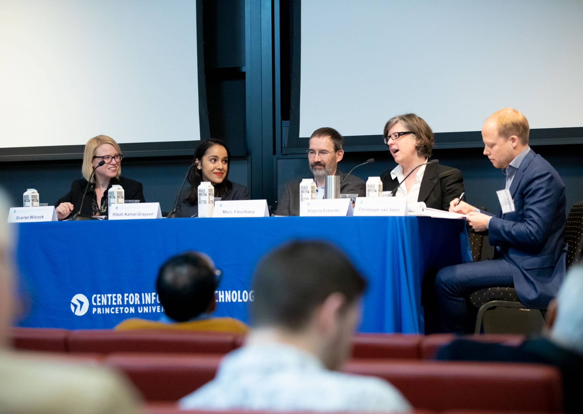 Panelists speaking at the conference