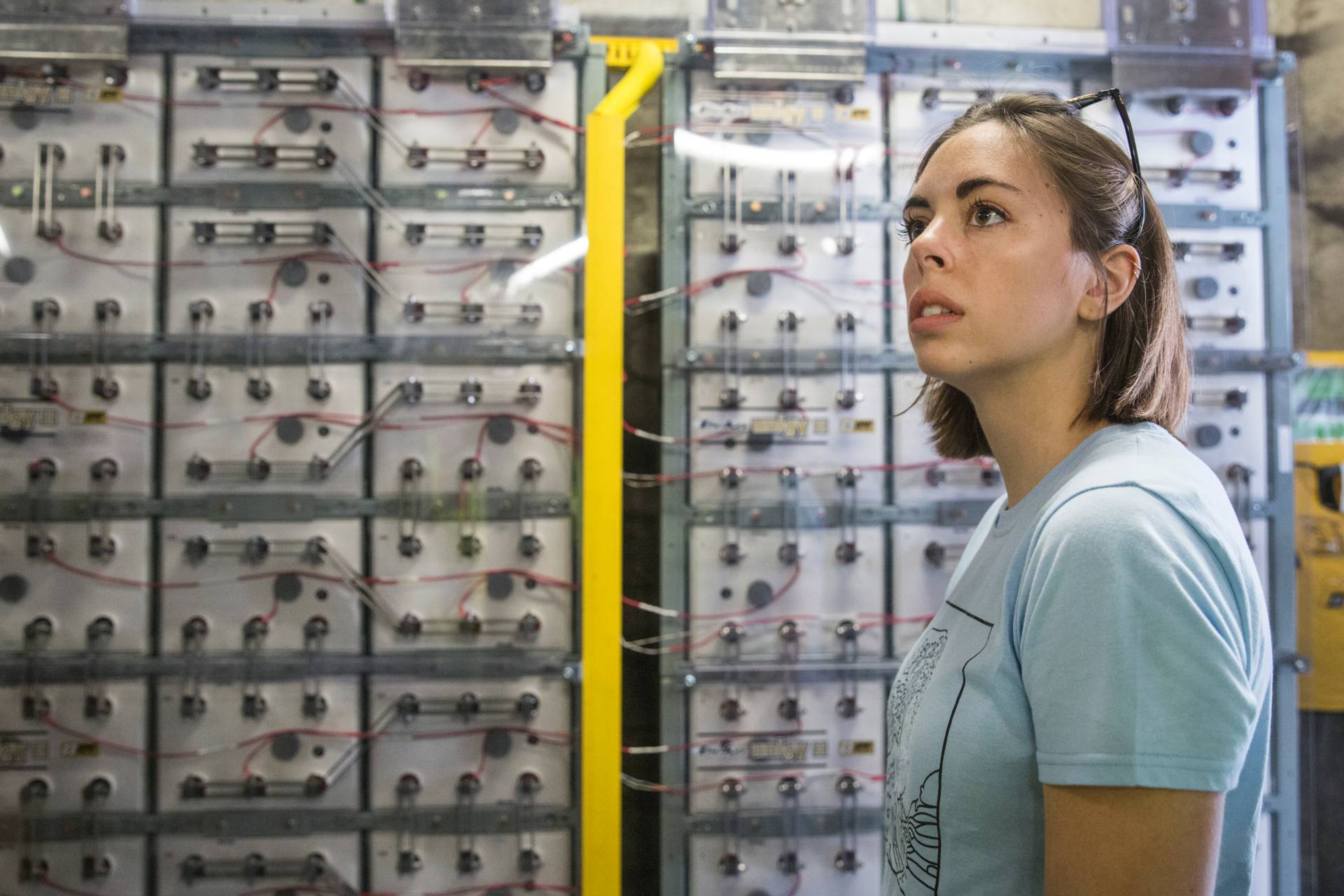 Erin Redding standing in front of battery bank
