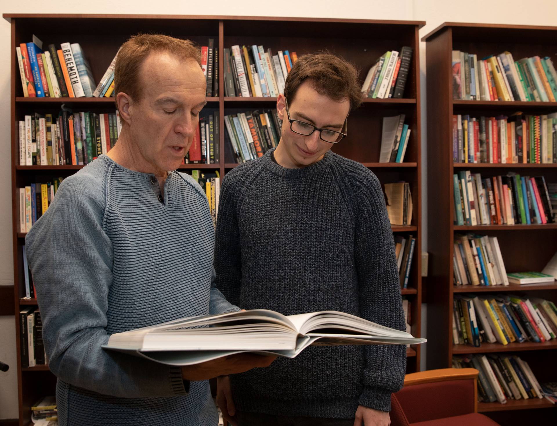 Robert Nixon and Jack Lohmann speak over a book