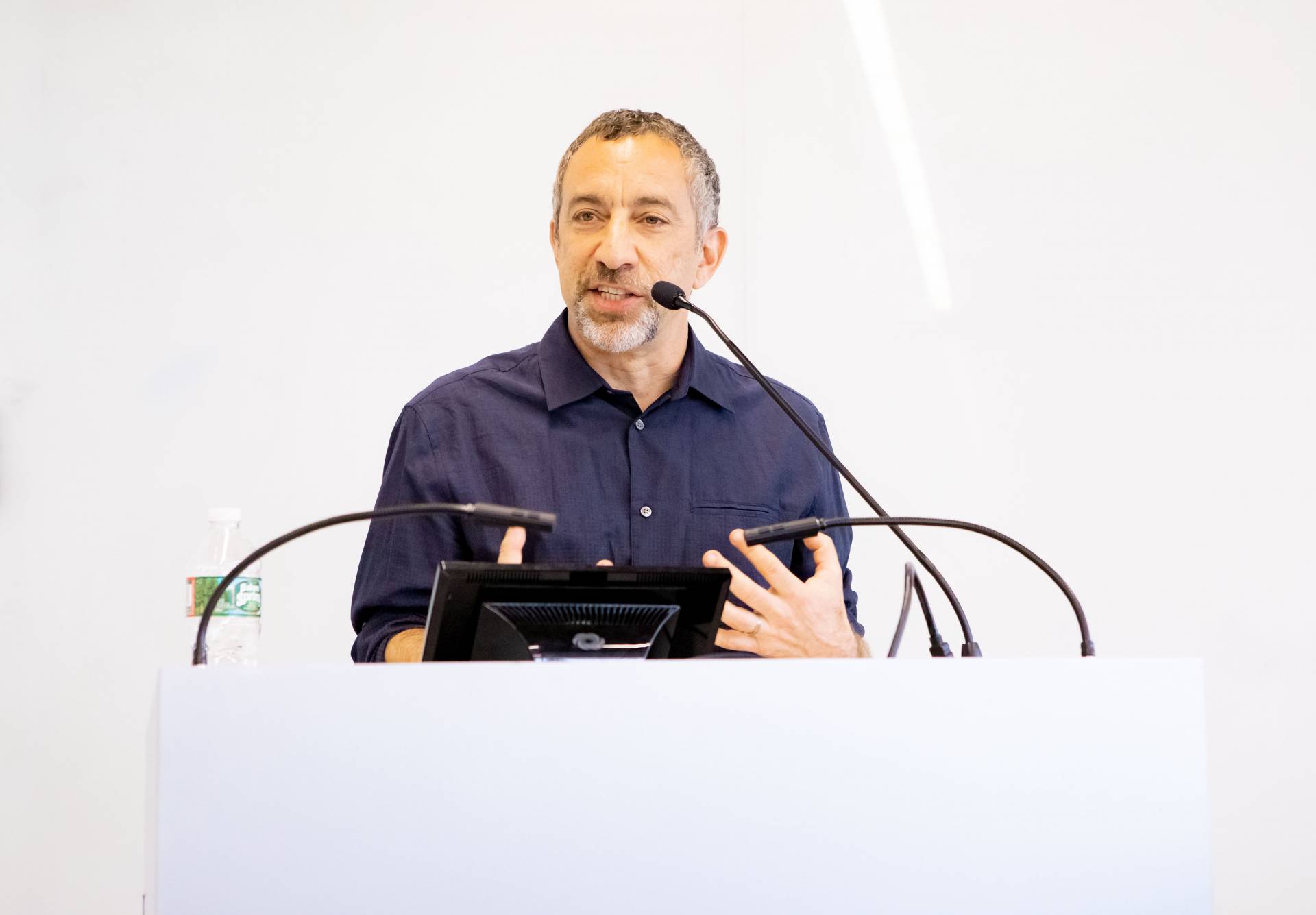 Joe Richman speaks at a podium