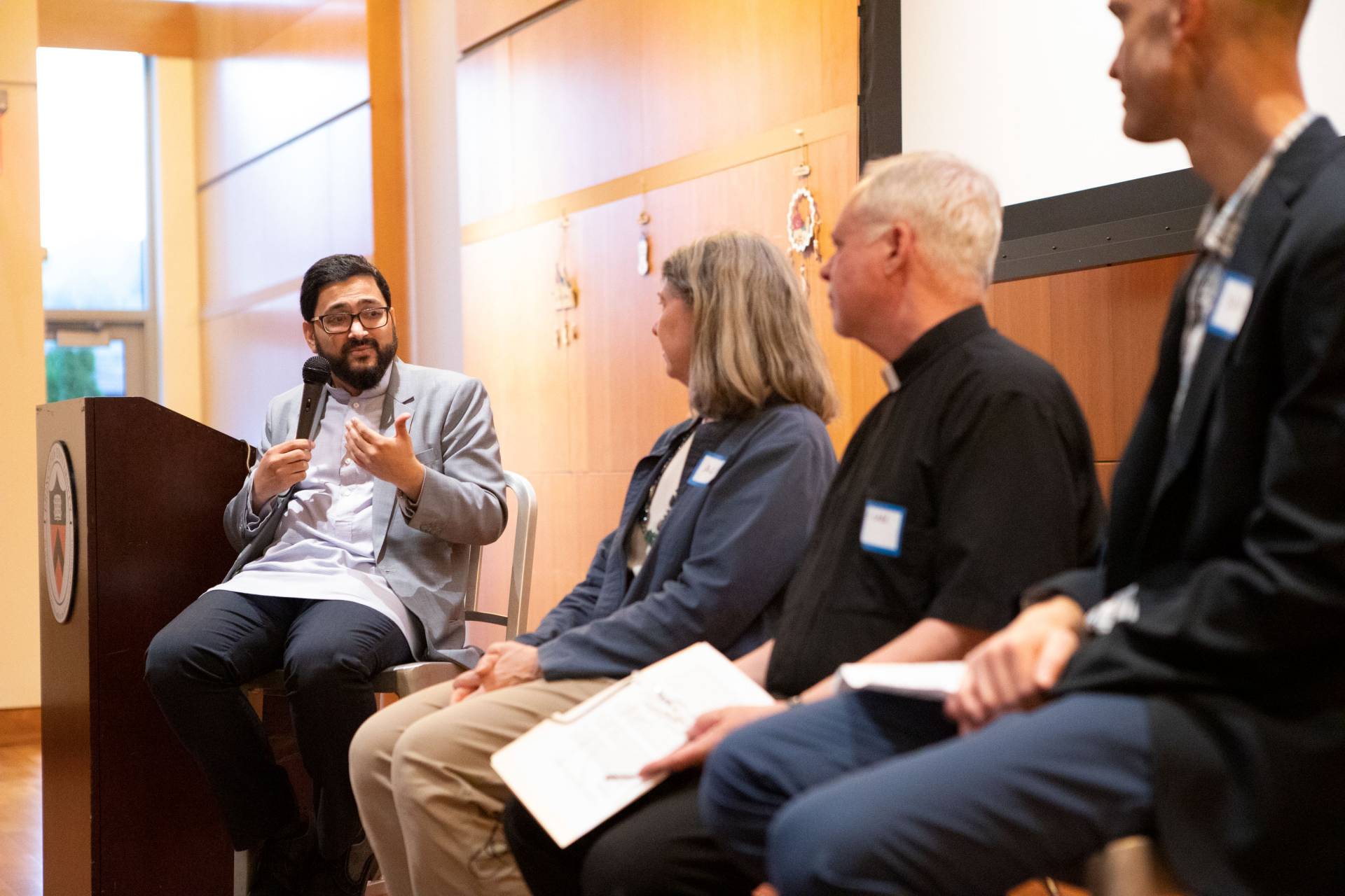 Sohaib Sultan speaking on panel during Interfaith dinner