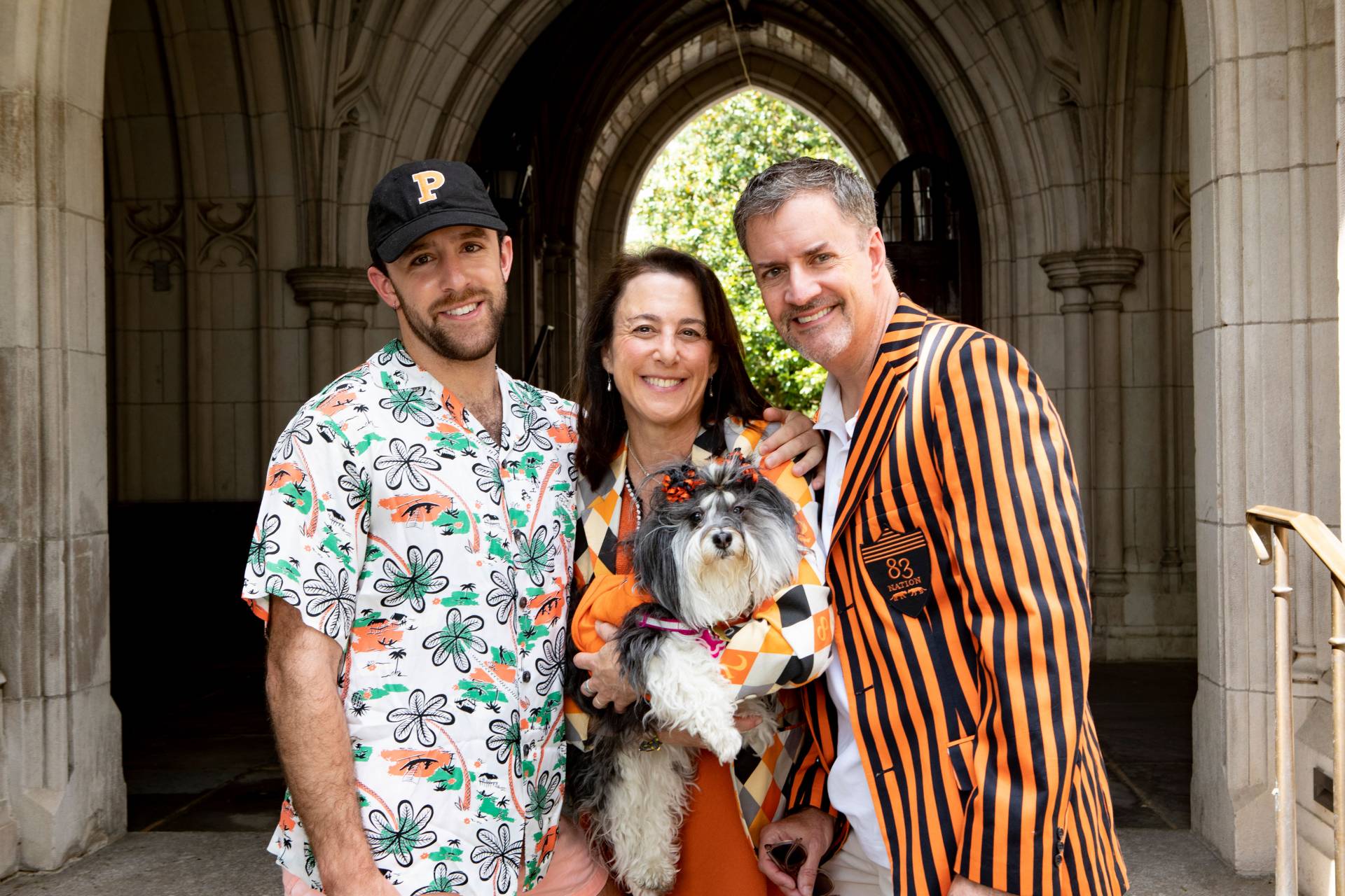 Alumni pose with a dog