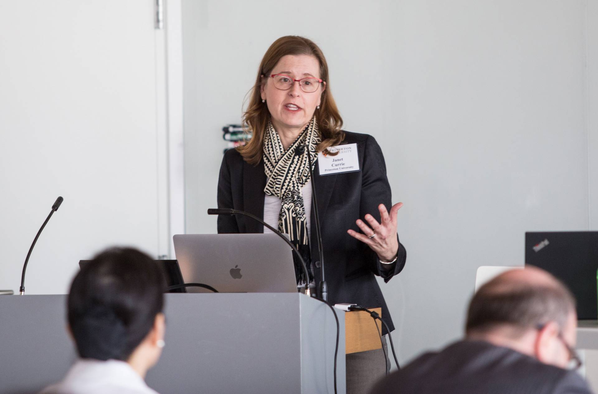 Janet Currie speaks in front of an audience
