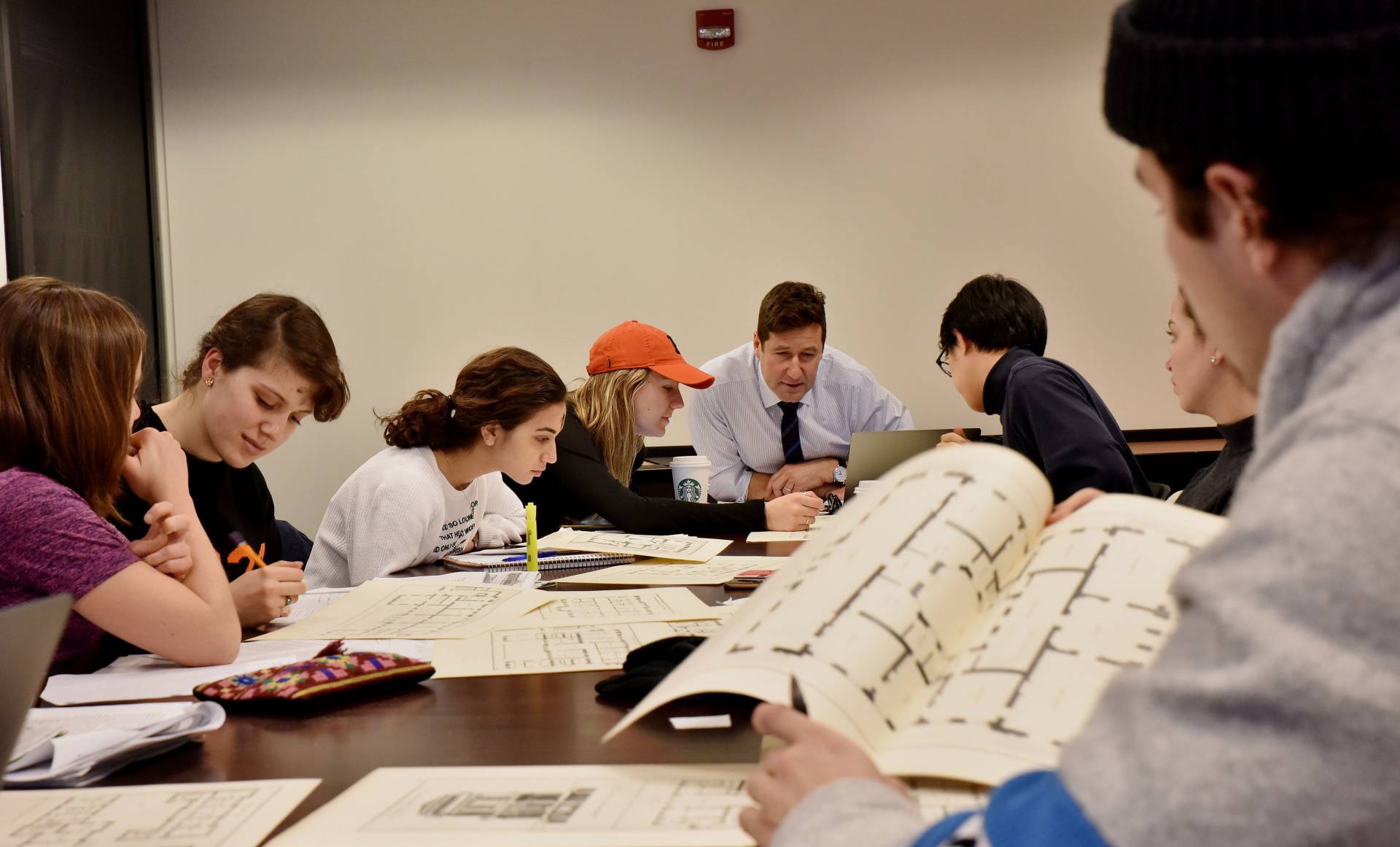 Art of Living class looks over blueprints