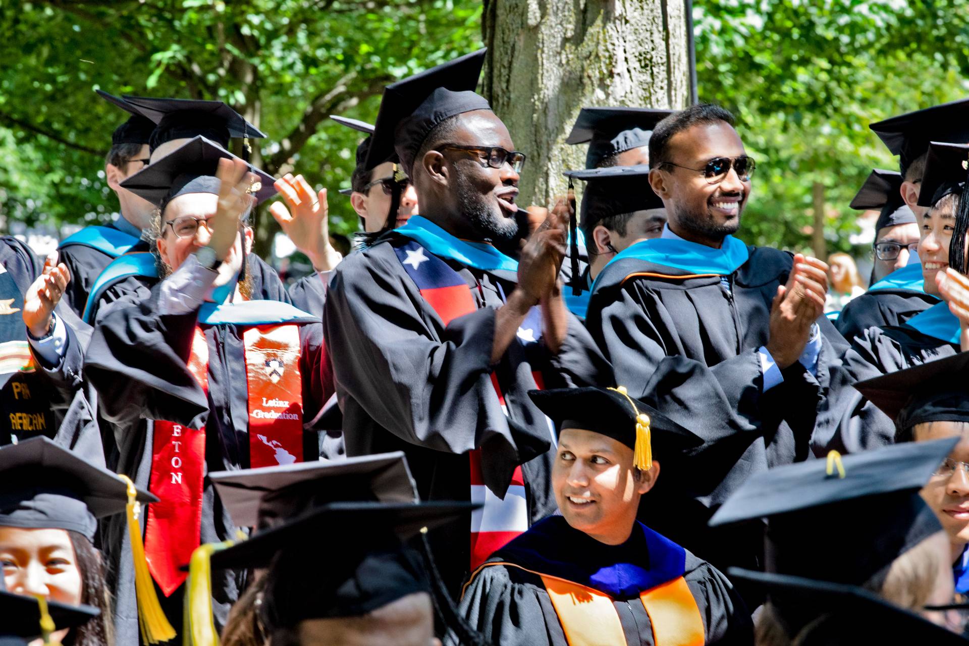 Students standing and clapping during the ceremony