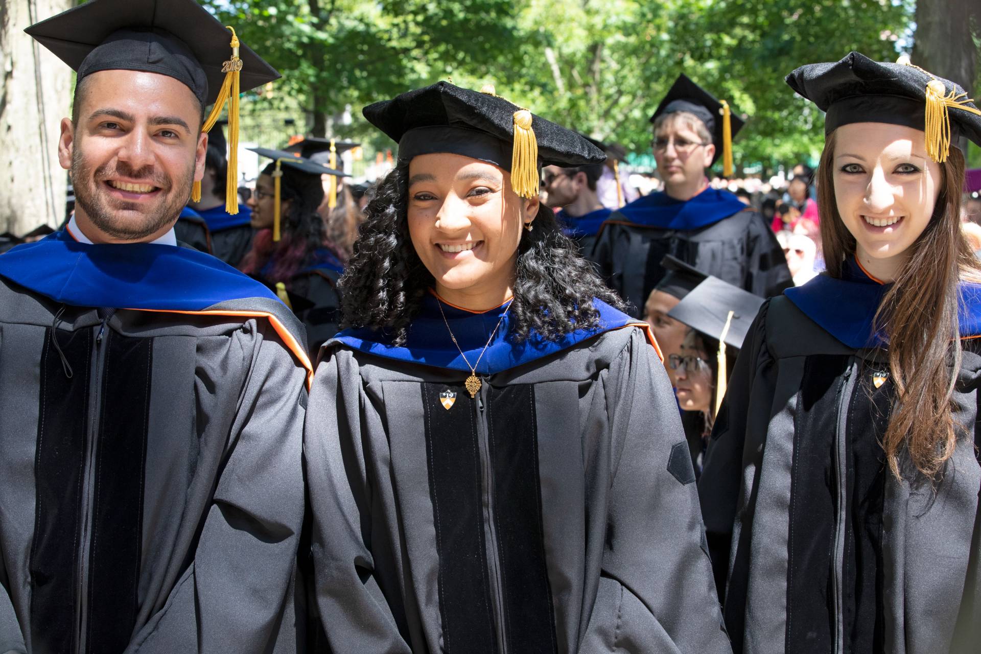 Students standing and smiling during ceremony
