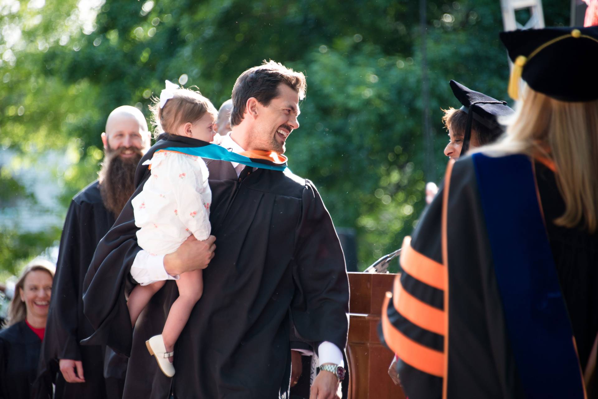 Marshall Thomas Boyd carrying his daughter on stage