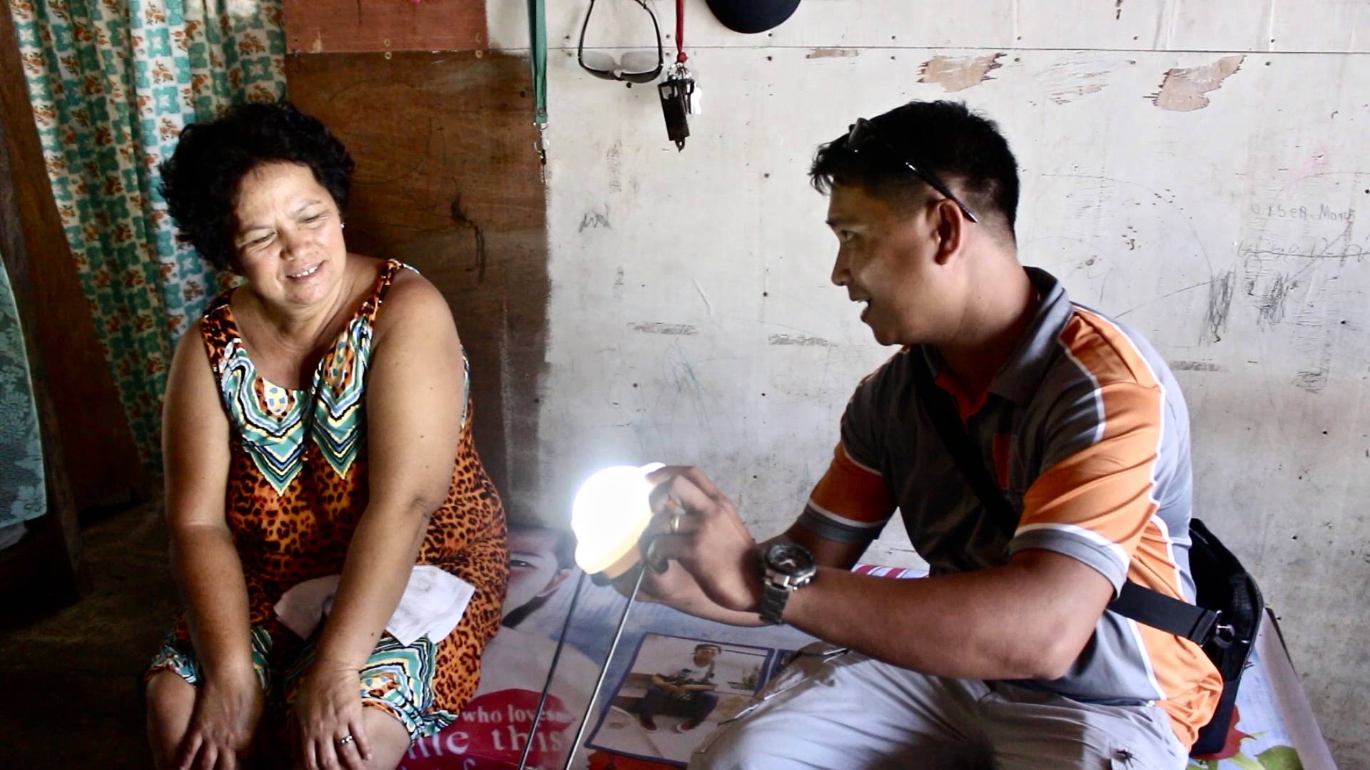 Villagers indoors shining a light