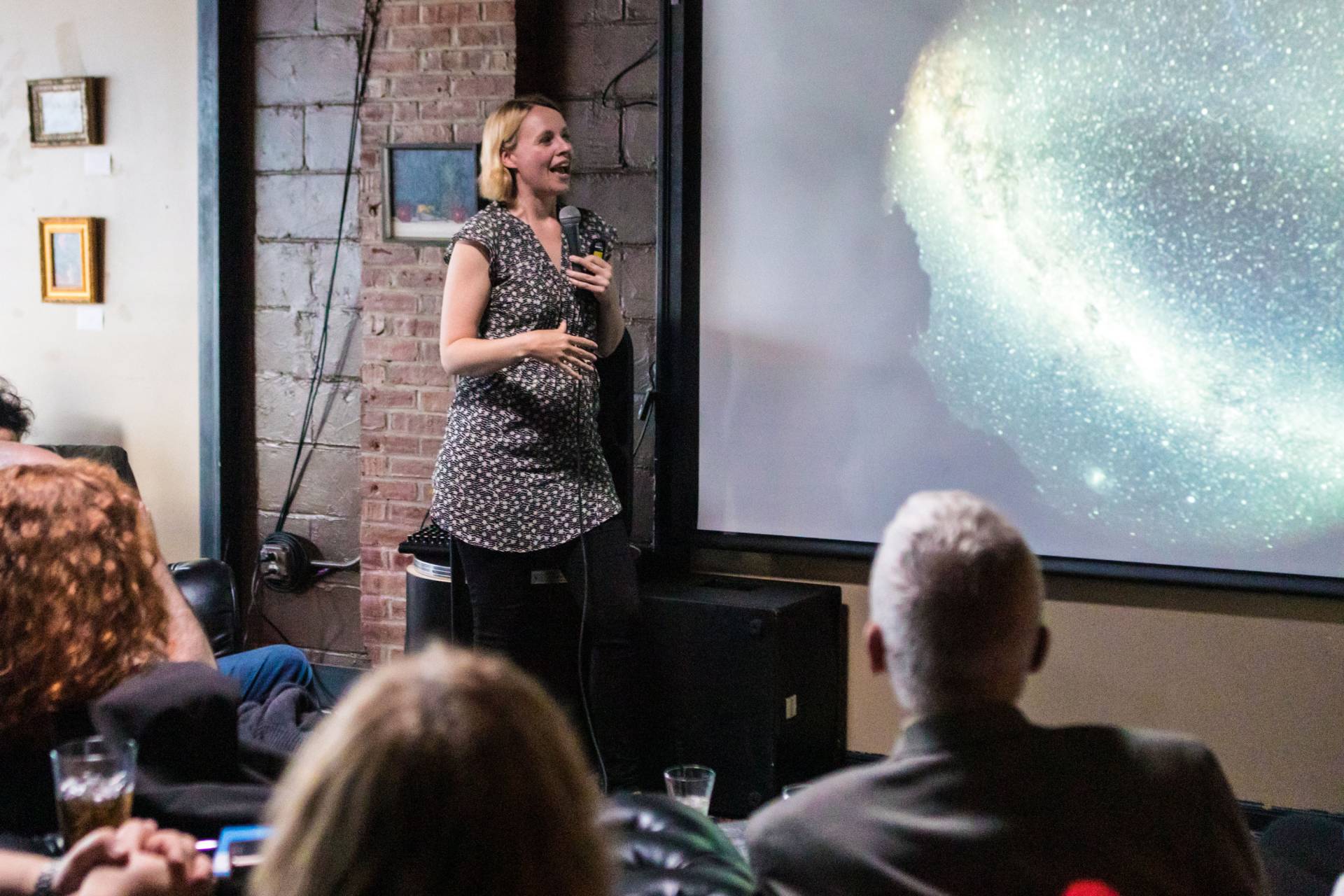 Jo Dunkley speaking next to projection screen