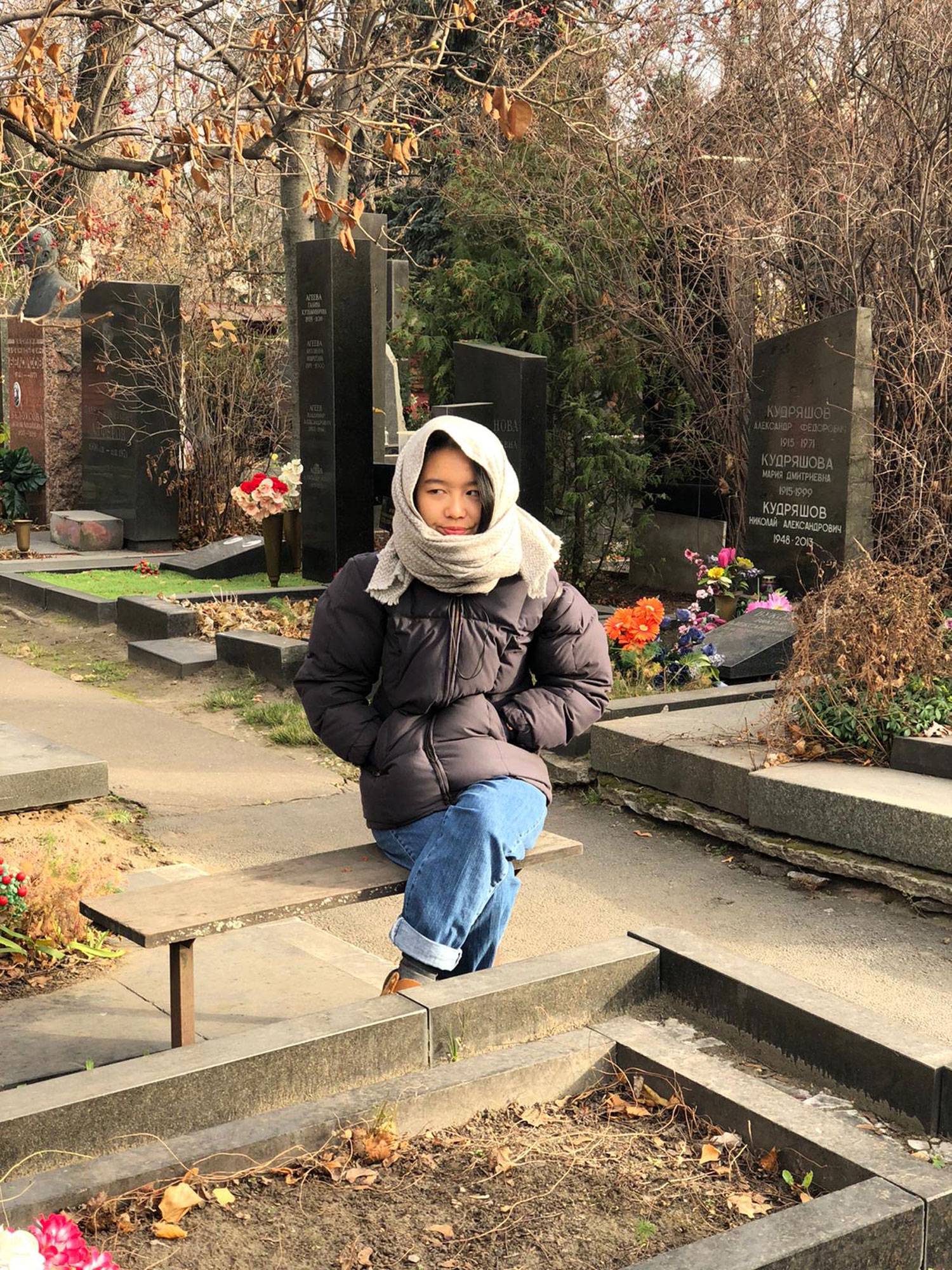 Student Sanna Lee sitting alone at Novodevichy Cemetery