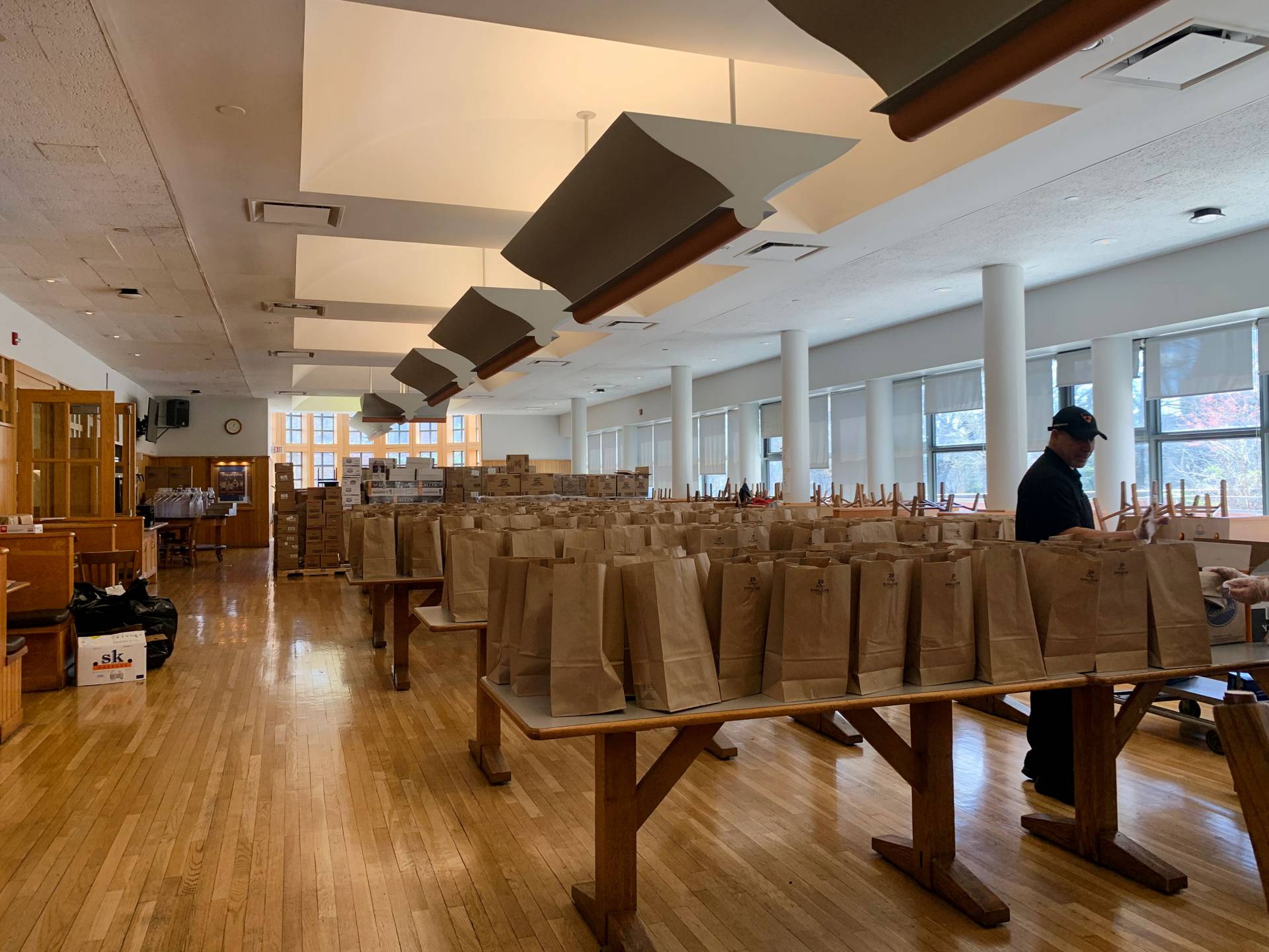 A staff member oversees the bags of dry food for students