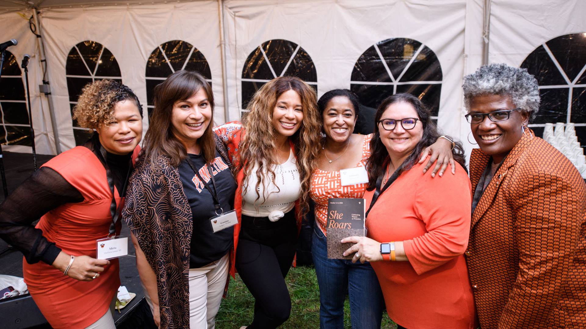 Kwanza Jones and sister Meta DuEwa Jones pose with attendees of She Roars