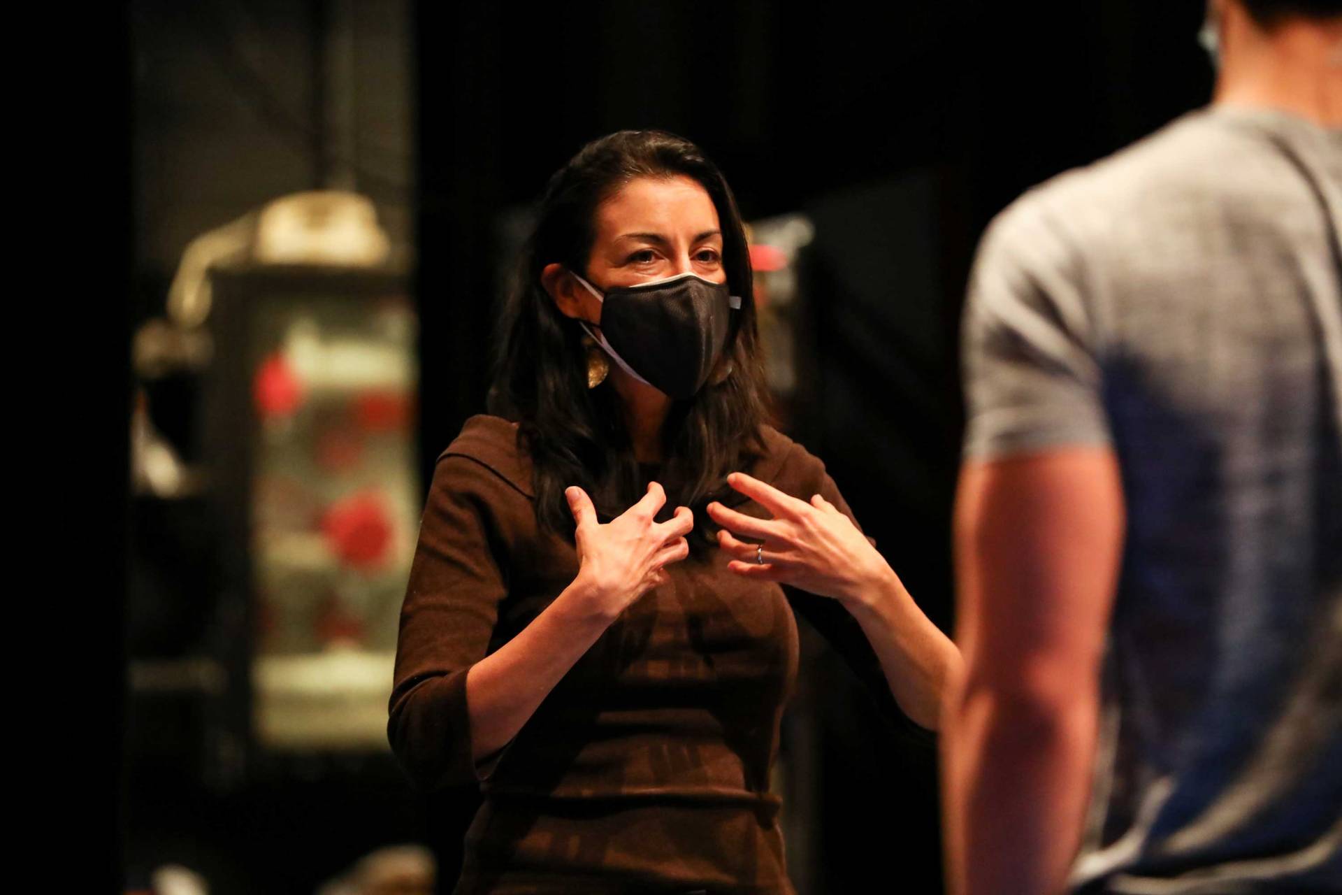 Araoz gesticulates while directing the students