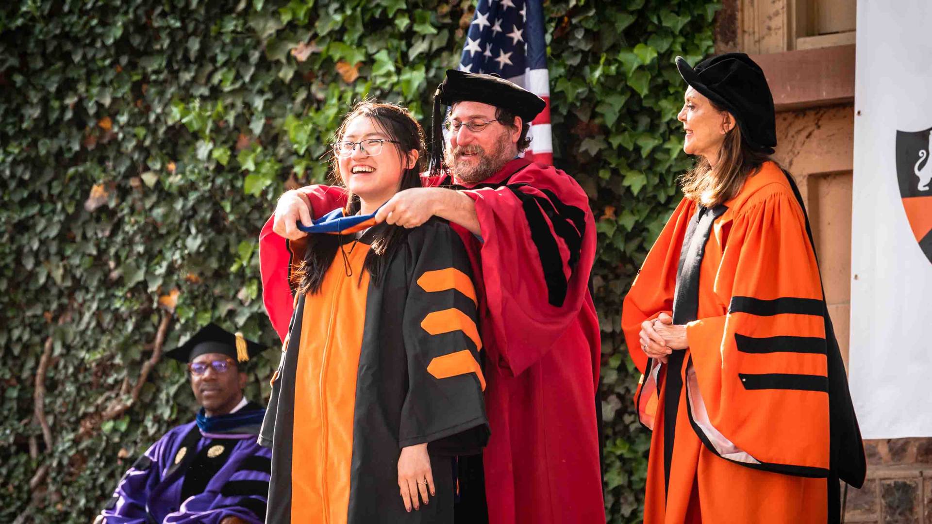 A graduate student being hooded by a professor