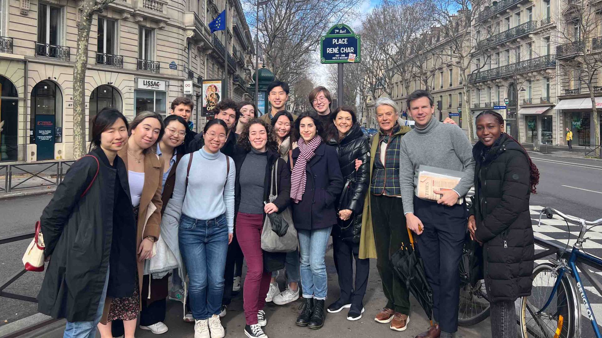 Students standing under a René Char sign