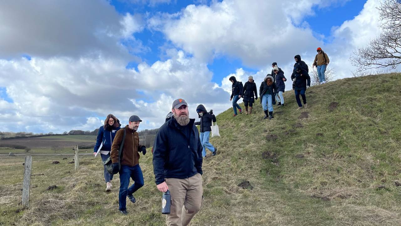 Students walking over a hill