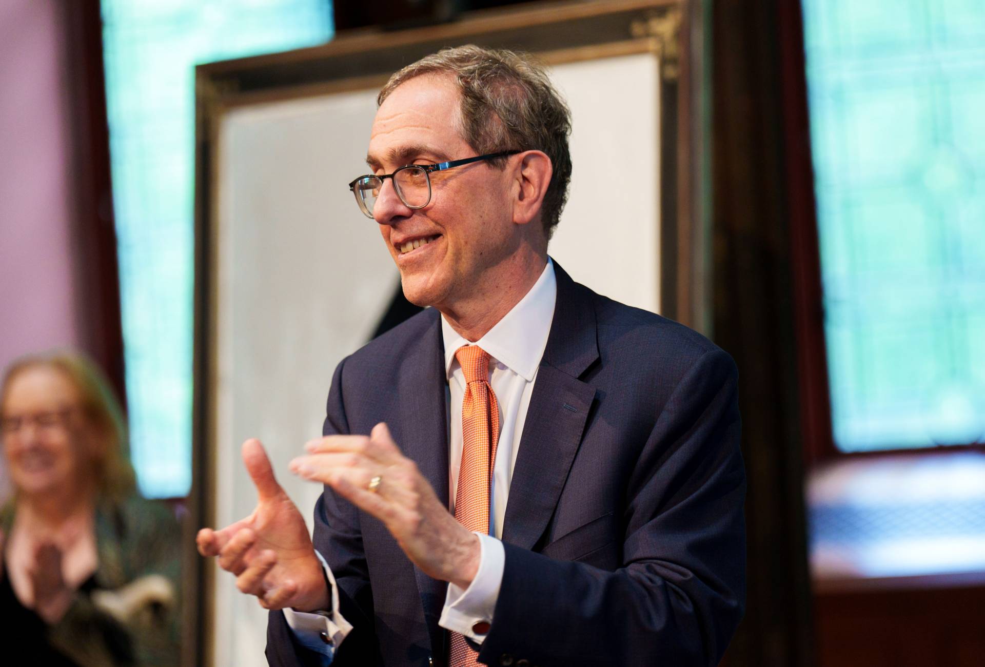 President Eisgruber claps during the event