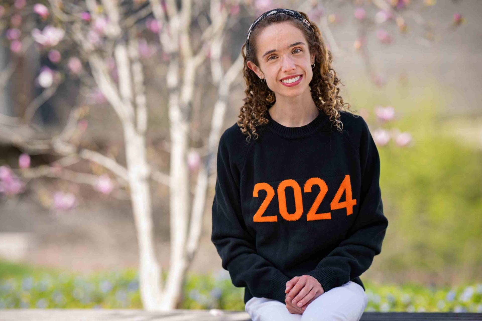 Amelie wearing her batch 2024 sweater.