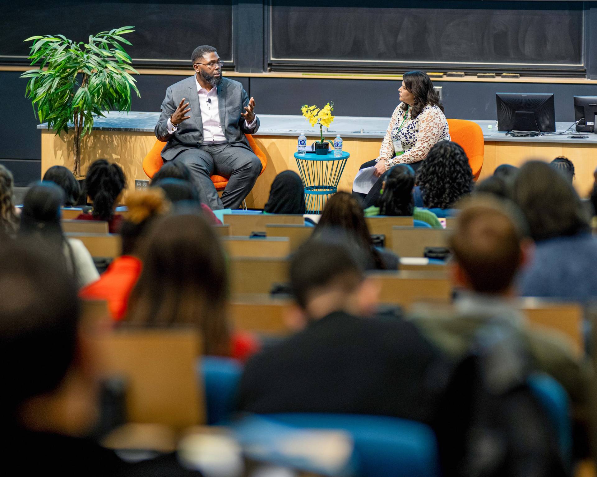 Anthony Abraham Jack in conversation with Khristina Gonzales in front of a crowd.