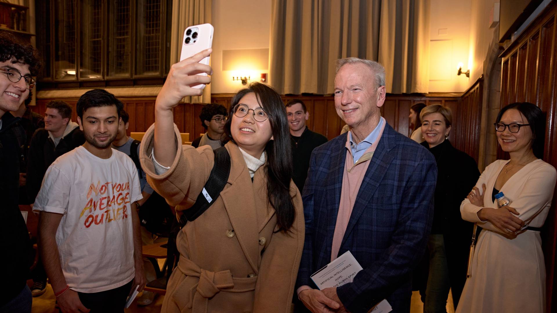 A student takes a selfie with Eric Schmidt