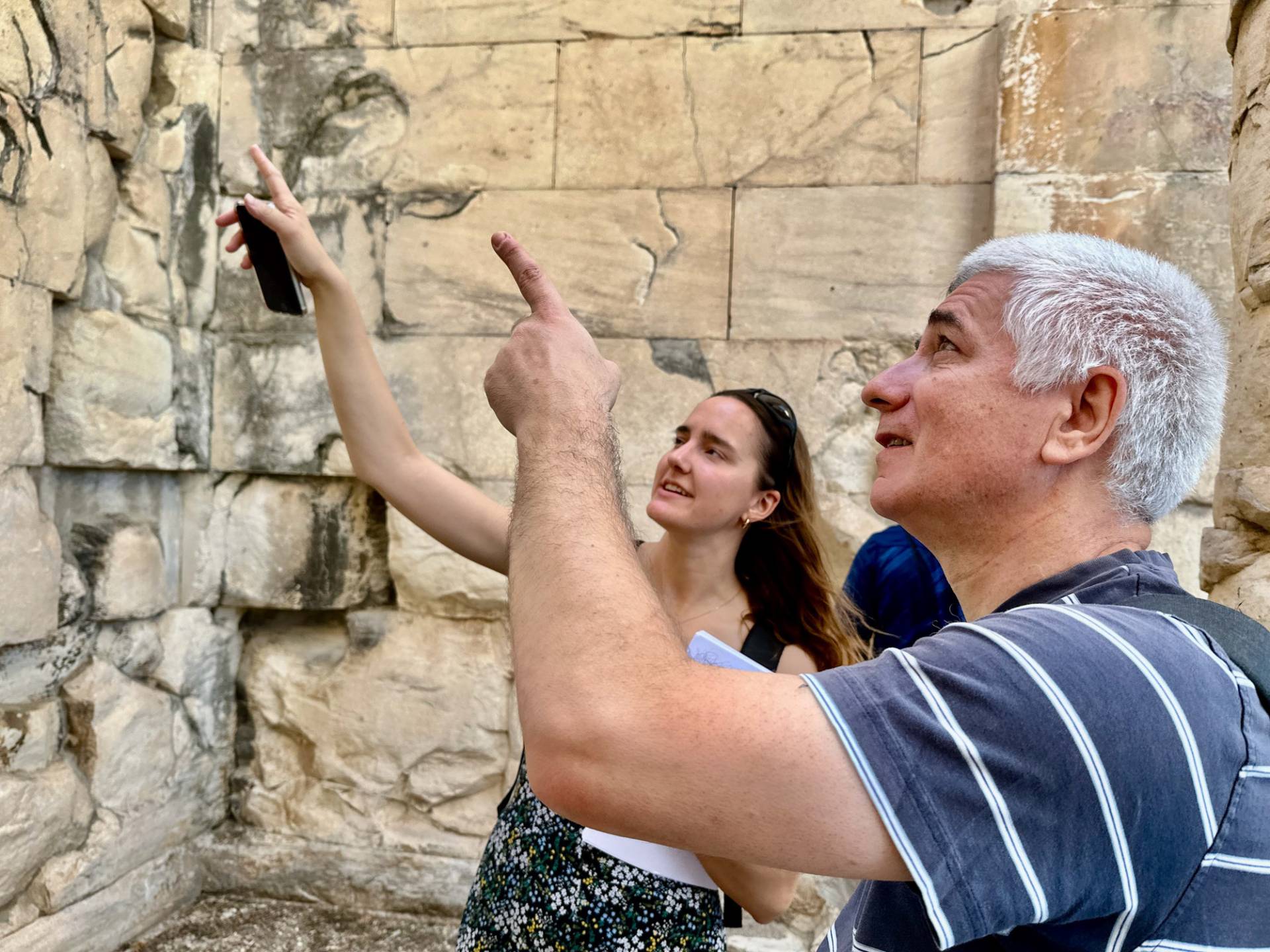 Professor Branko Glišić with a student in Greece, pointing to a wall.