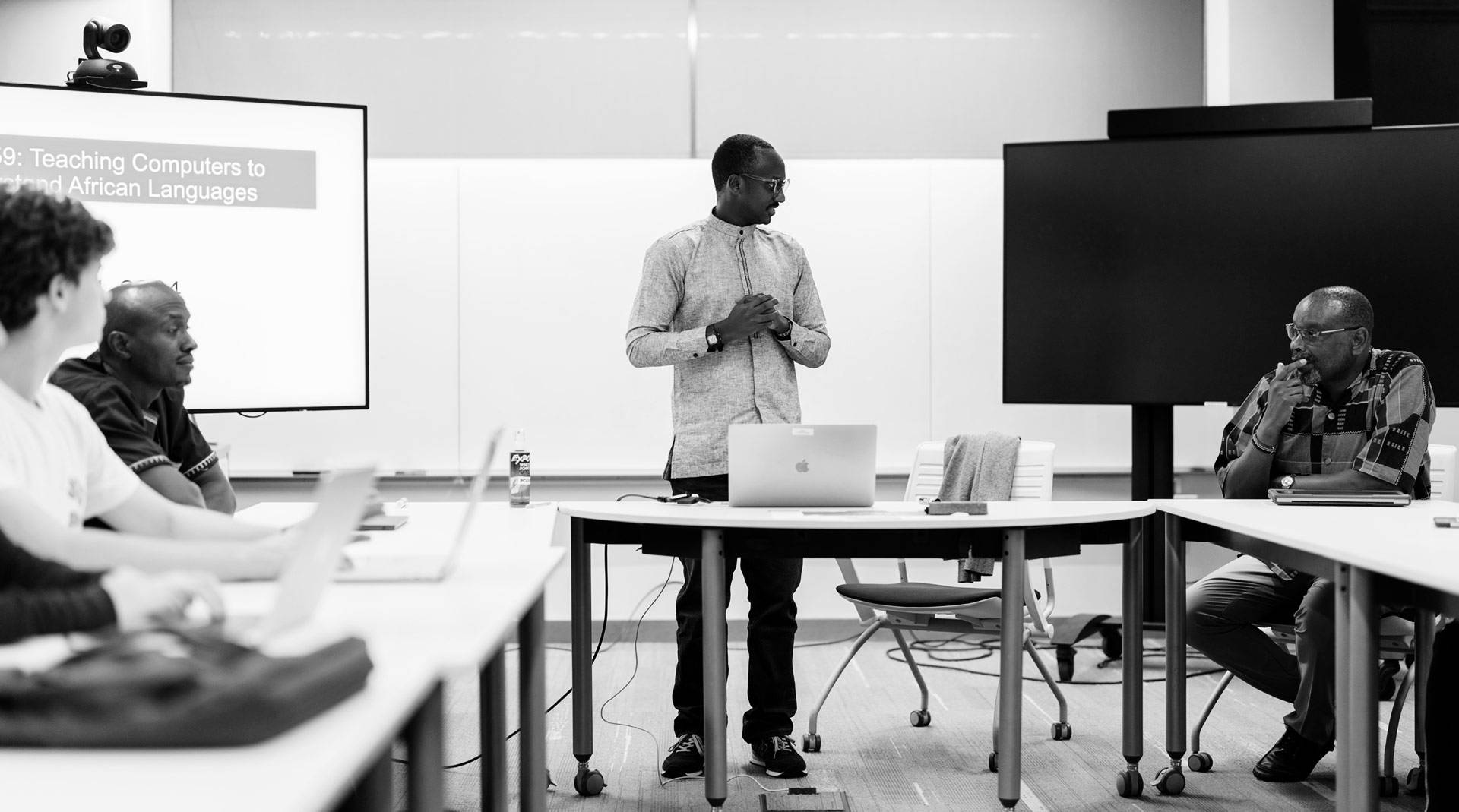 Buzaaba, Mwita, and Ernest having a discussion