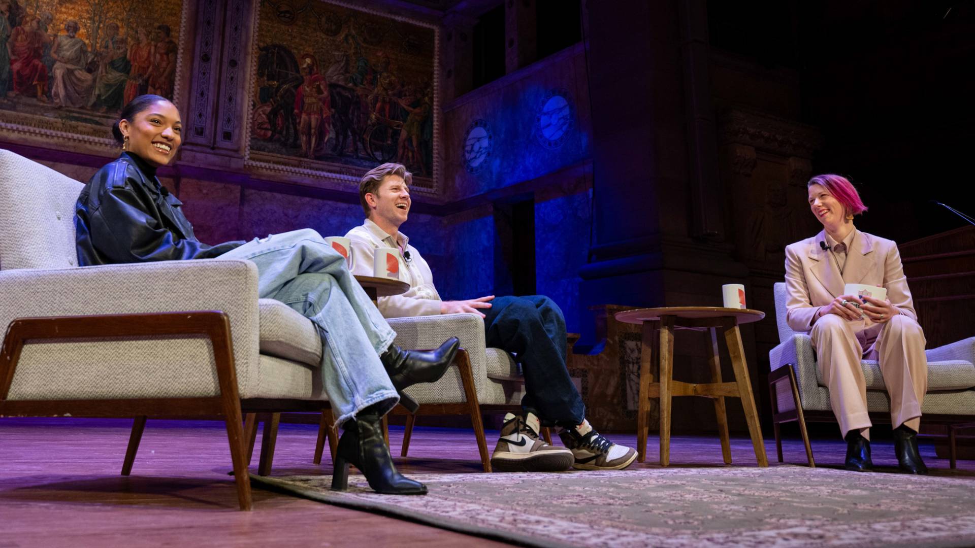 Tara Davis-Woodhall, and Hunter Woodhall with Judy Jarvis on stage.