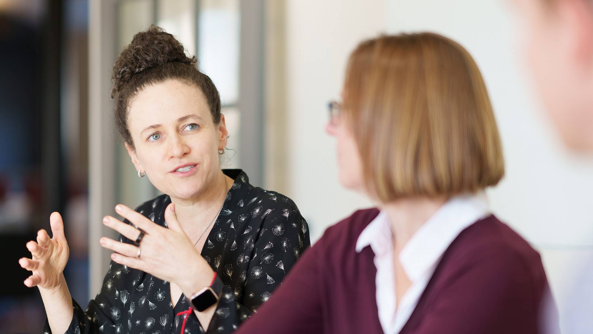Woman speaks while colleagues listen