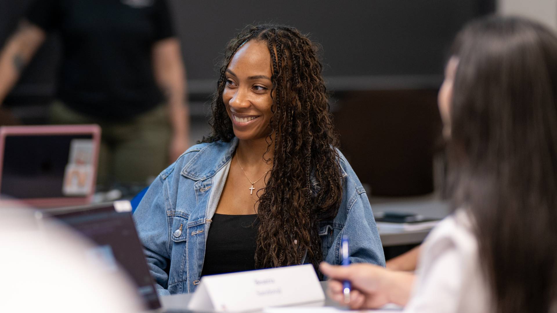 Student sits in class speaking with other WSP-Princeton participants
