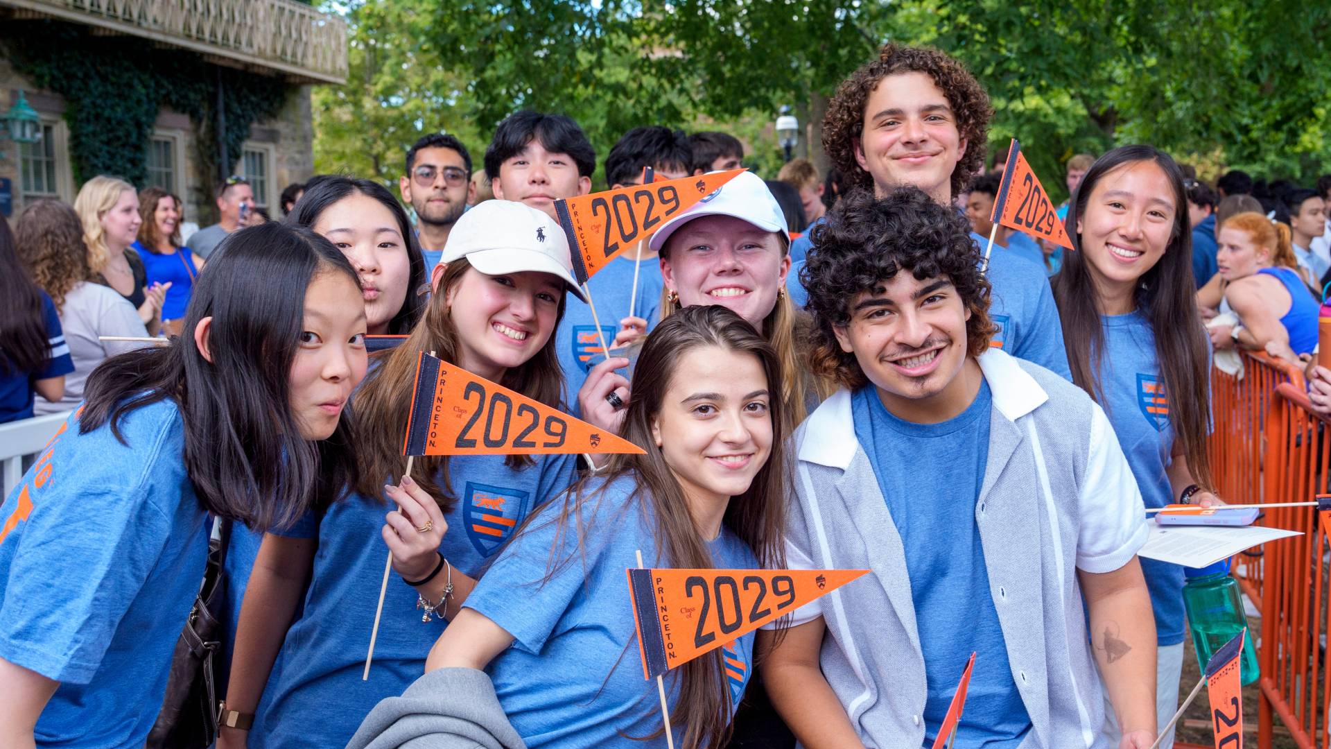 Students in blue shirts hold Class of 2029 flags