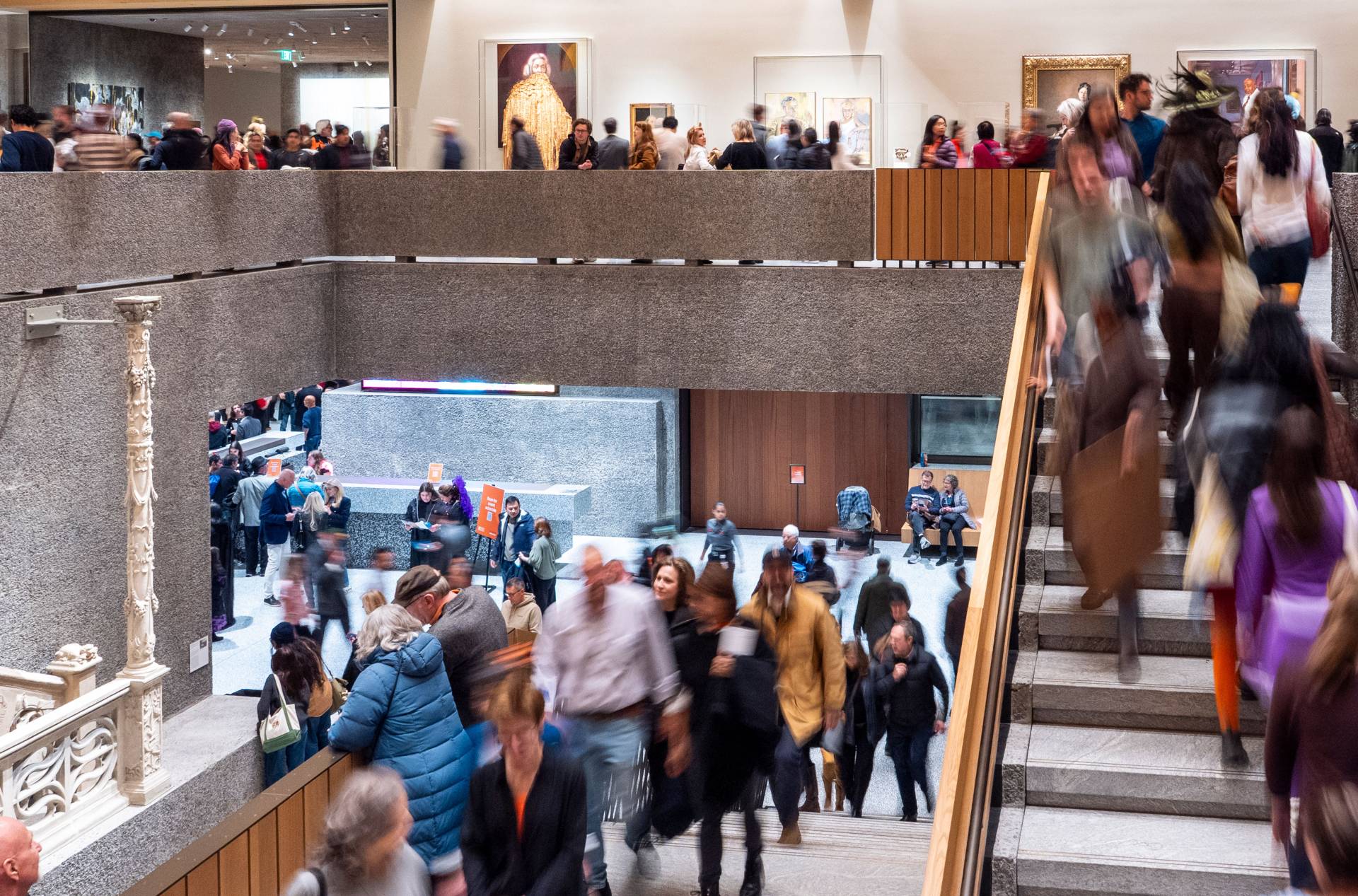 People fill the main floor and Orientation Gallery on the second floor of the art museum..