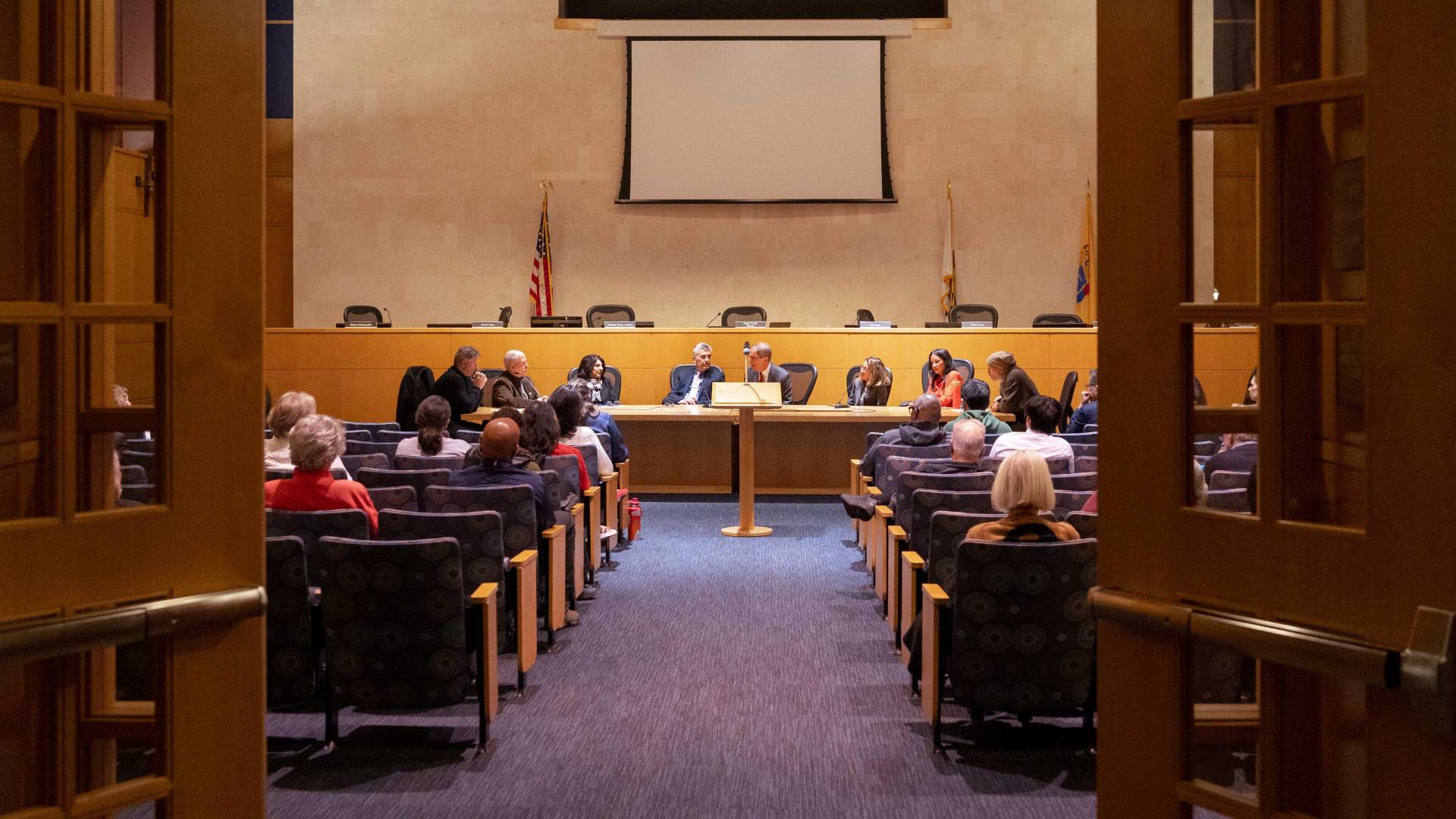 An audience listens to Princeton municipal council meeting