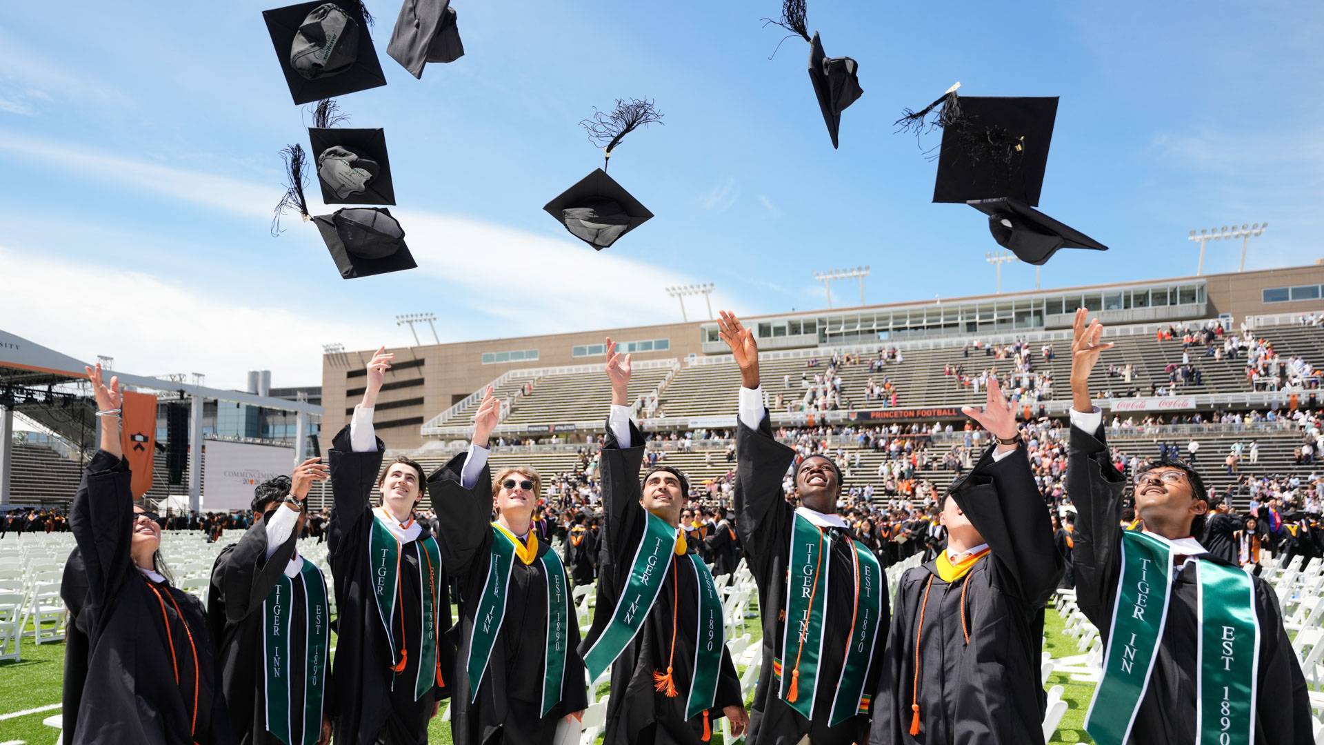 Graduates throw caps in air