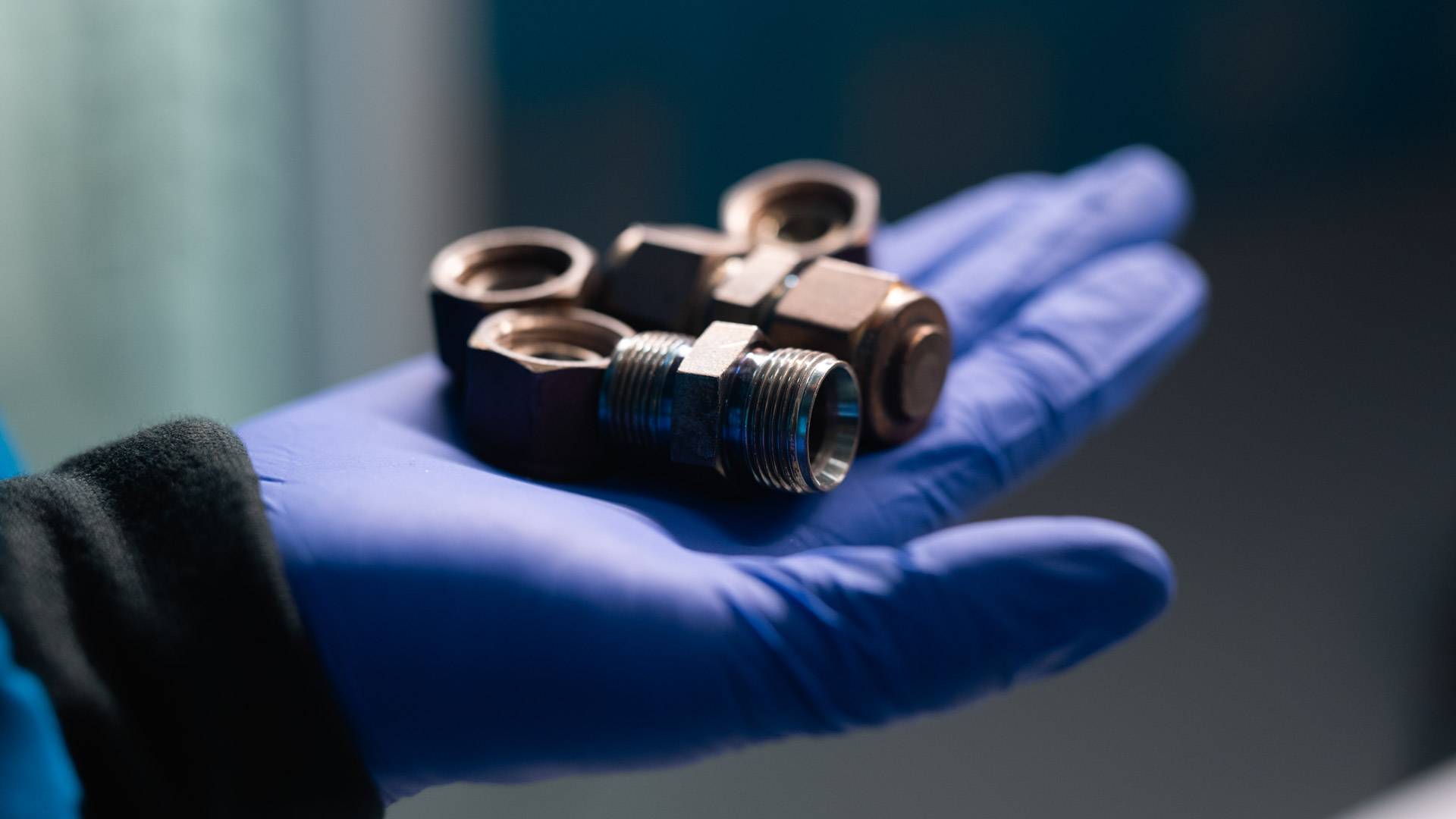 A close-up view of  mini chemical reactors made from repurposed stainless steel pipe connectors