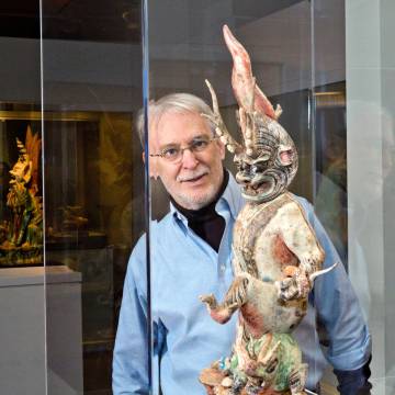 Professor looking at sculpture