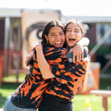 two female students hug
