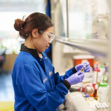 Lab worker using vials