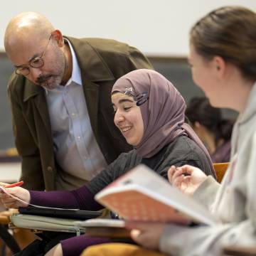 a professor with two students in a classroom