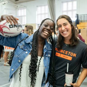 two students smiling at the activities fair