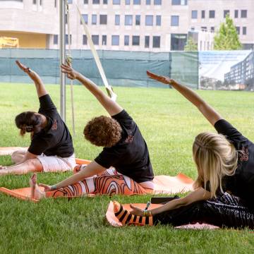 alumni in a yoga pose