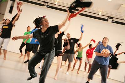 Harvey and her students use scarves to accentuate their movements as she teaches them a new Africanist dance sequence.