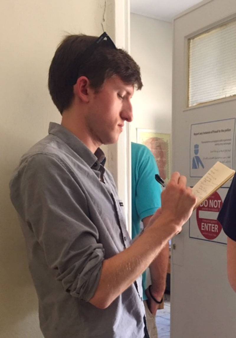 A Tale of Two Countries: Greece - Harrison Blackman taking notes at Schisto main office