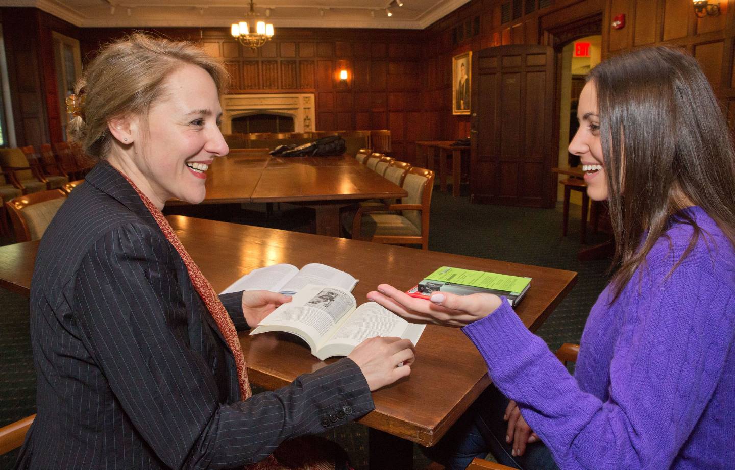 Student and professor discuss a book
