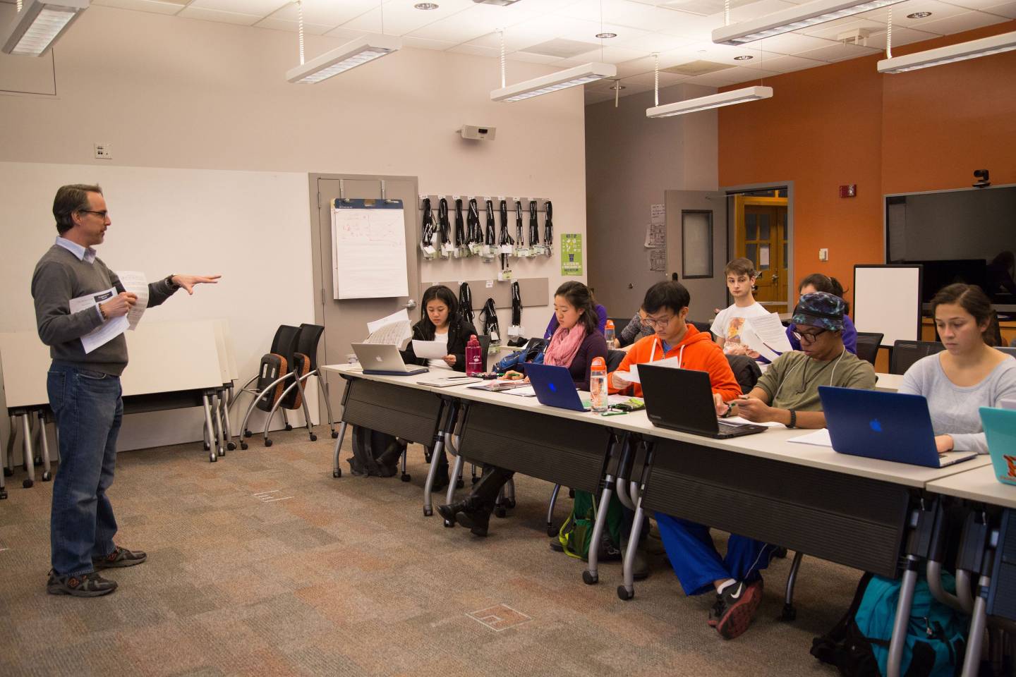 A professor stands and teaches a class at the McGraw Center