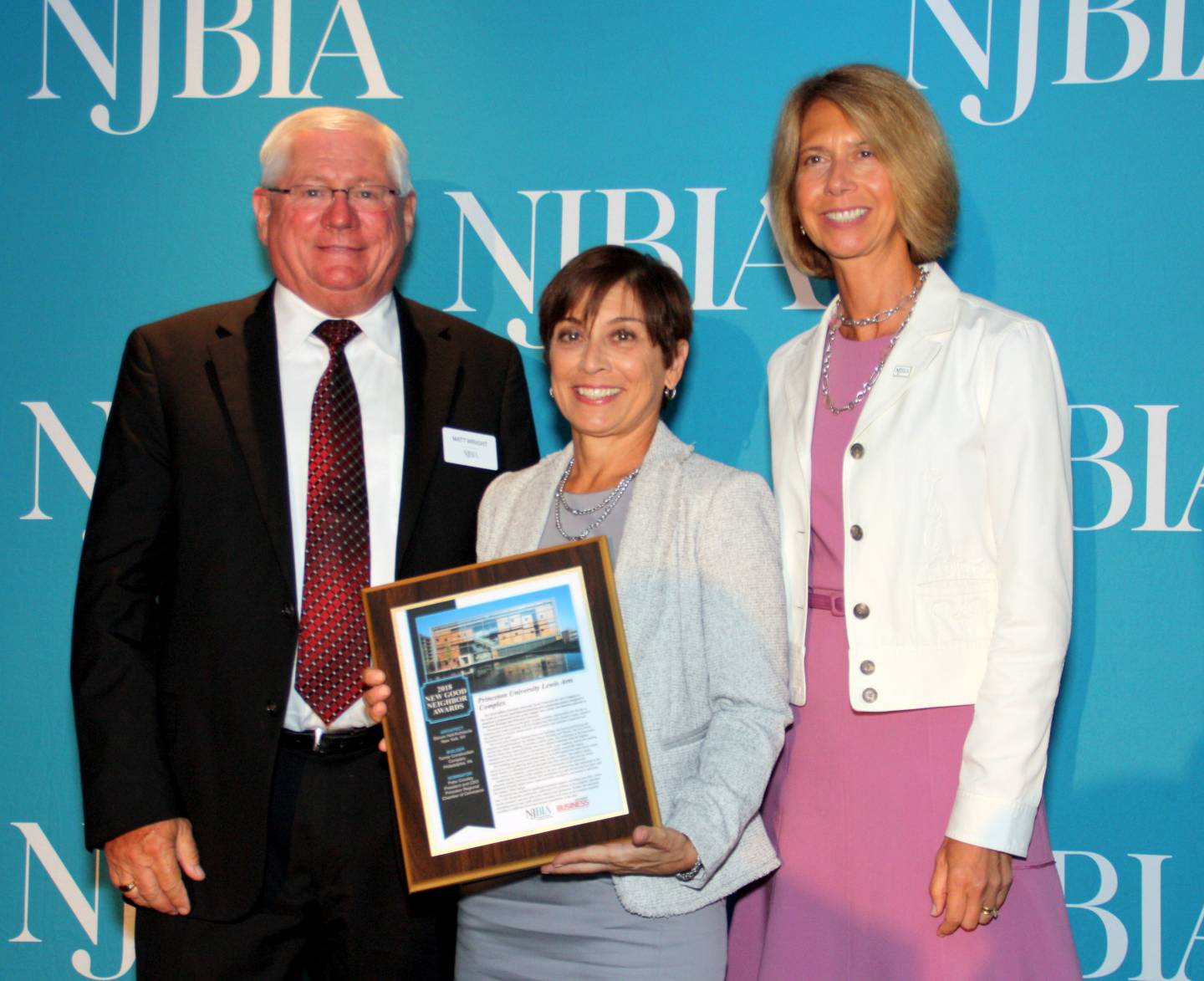 Karen Jezierny holds the NJBIA Good Neighbor Award with Matthew Wright and Michele Siekerka