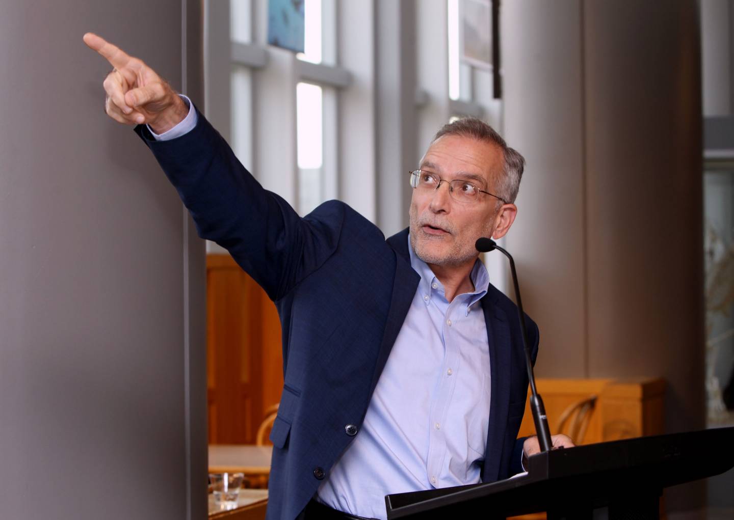 Michael Celia points at photo exhibition