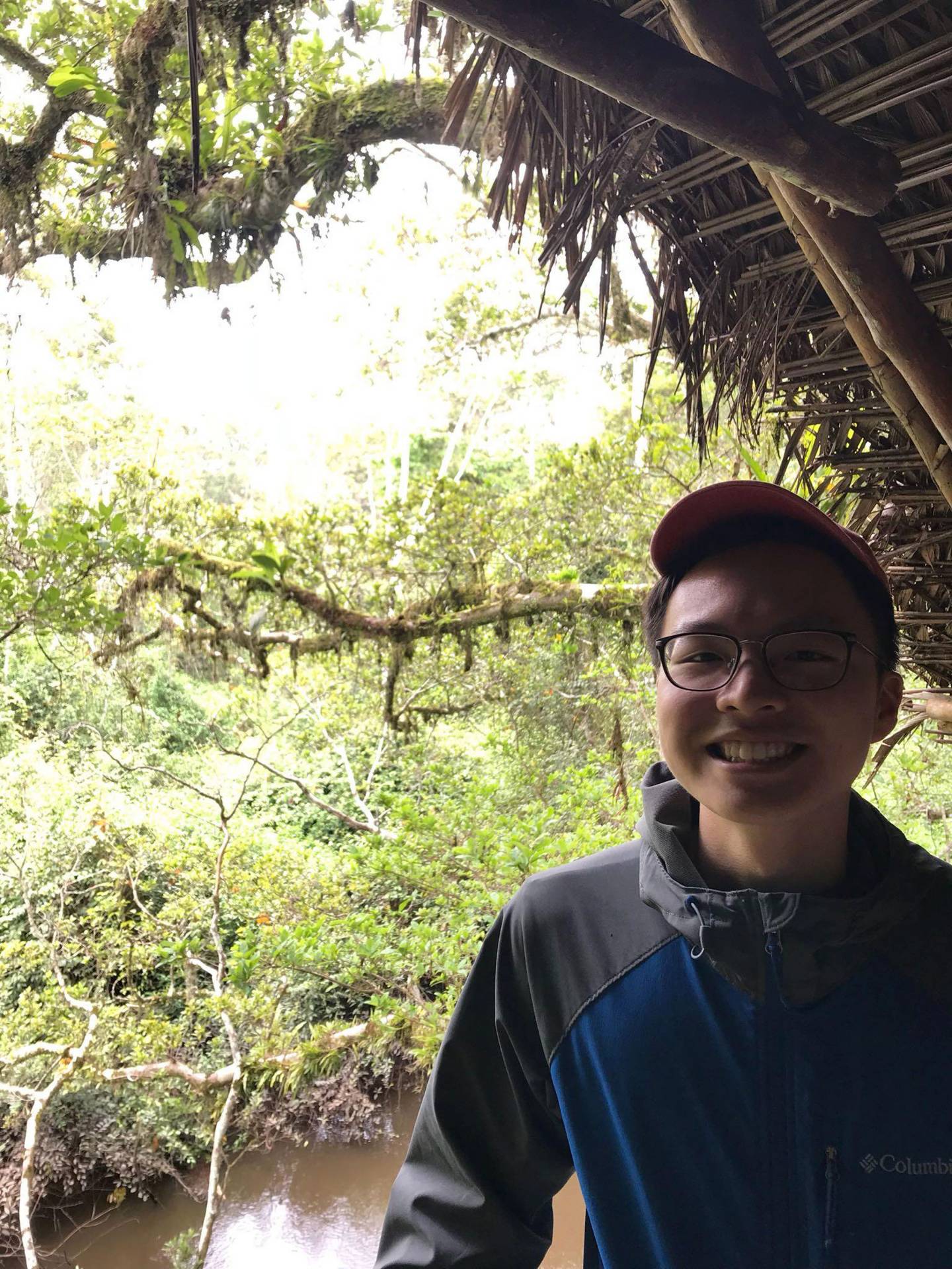 Lap Hei Lam standing in front of jungle